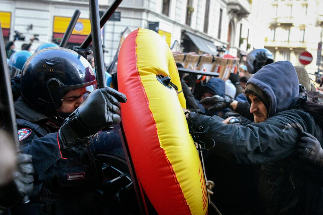 Police officers and demonstrators clash during an “anti-fascist” and “anti-racist” march to protest against a Lega Nord Party general election campaign rally on Piazza Duomo in Milan on Feb. 24, 2018. (Francesca Volpi/Getty Images)