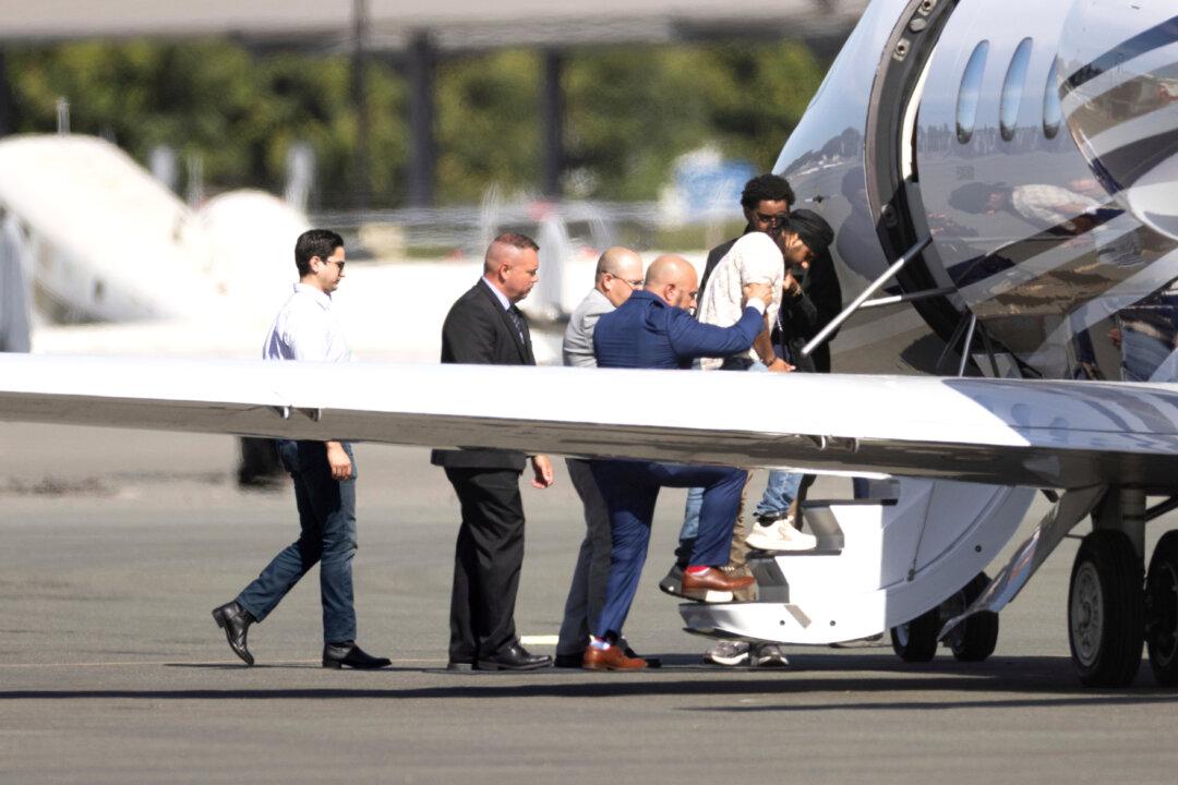 Harjinder Singh is escorted onto an airplane by Florida Lt. Gov. Jay Collins and law enforcement in Stockton, Calif., on Aug. 21, 2025. Singh, a semitruck driver, made an illegal U-turn on Florida's Turnpike in August, steering his 18-wheeler across multiple high-speed lanes and killing three people in a minivan that crashed into his trailer. (Benjamin Fanjoy/File/AP Photo)