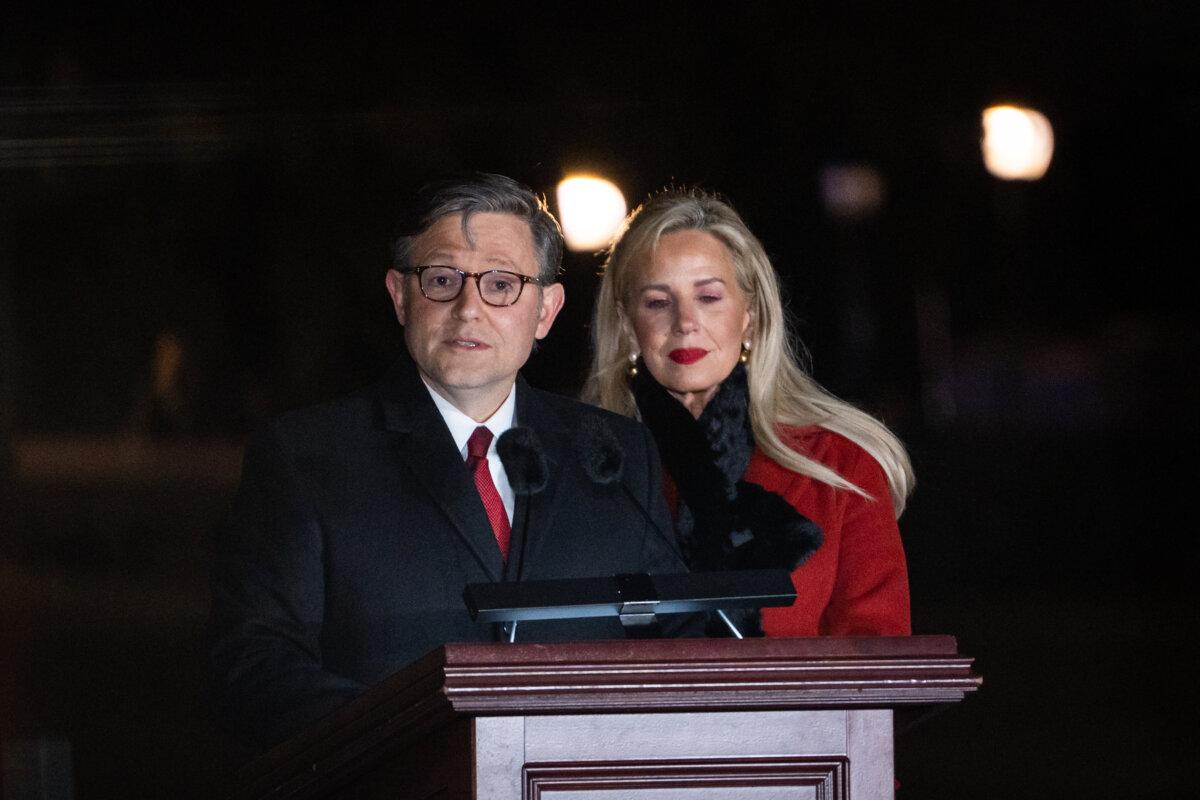 House Speaker Mike Johnson (R-La.), joined by his wife, Kelly Lary, speaks during the U.S. Capitol Christmas tree lighting ceremony on the West Front Lawn of the Capitol in Washington on Dec. 2, 2025. (Madalina Kilroy/The Epoch Times)