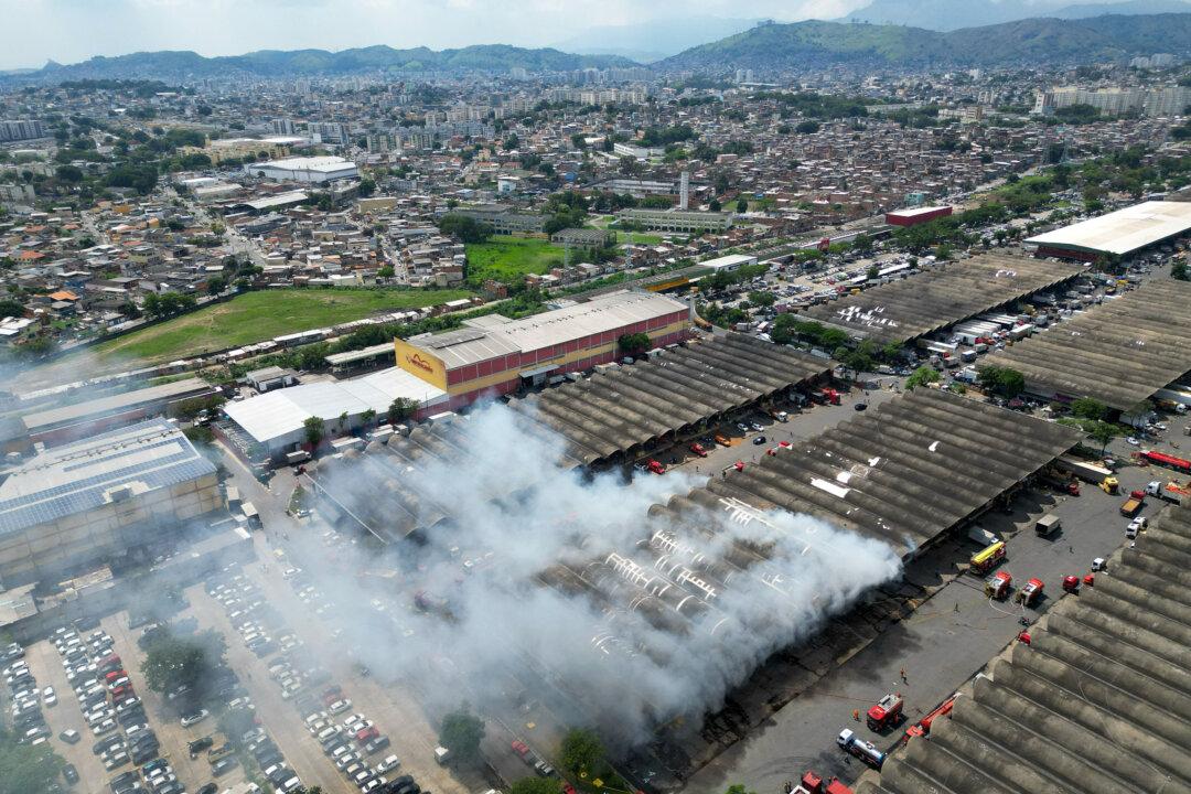 A fire rages at a state food distribution center in the Iraja neighborhood of Rio de Janeiro, Brazil, on Dec. 3, 2025. (Mauro Pimentel/AFP via Getty Images)