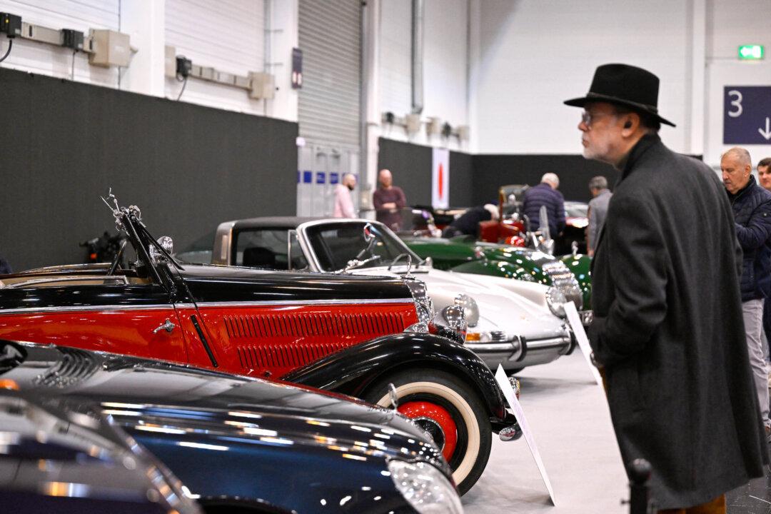 A visitor looks at vintage cars at the Essen Motor Show in Essen, Germany, on Dec. 3, 2025. The show takes place from Nov. 29 to Dec. 7, 2025. (Ina Fassbender/AFP via Getty Images)