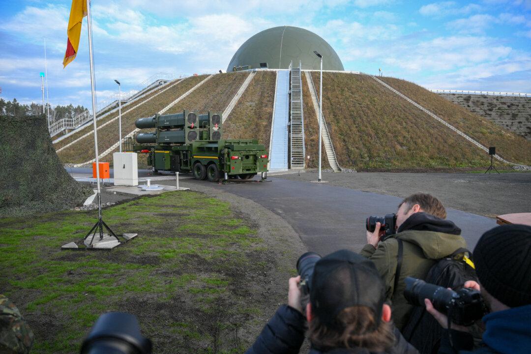 Photographers take pictures of the Arrow 3 shield system and a radar dome at a German Air Force event for the Arrow Weapon System at the Annaburger Heide Air Base in Holzdorf, Germany, on Dec. 3, 2025. (Ralf Hirschberger/AFP via Getty Images)