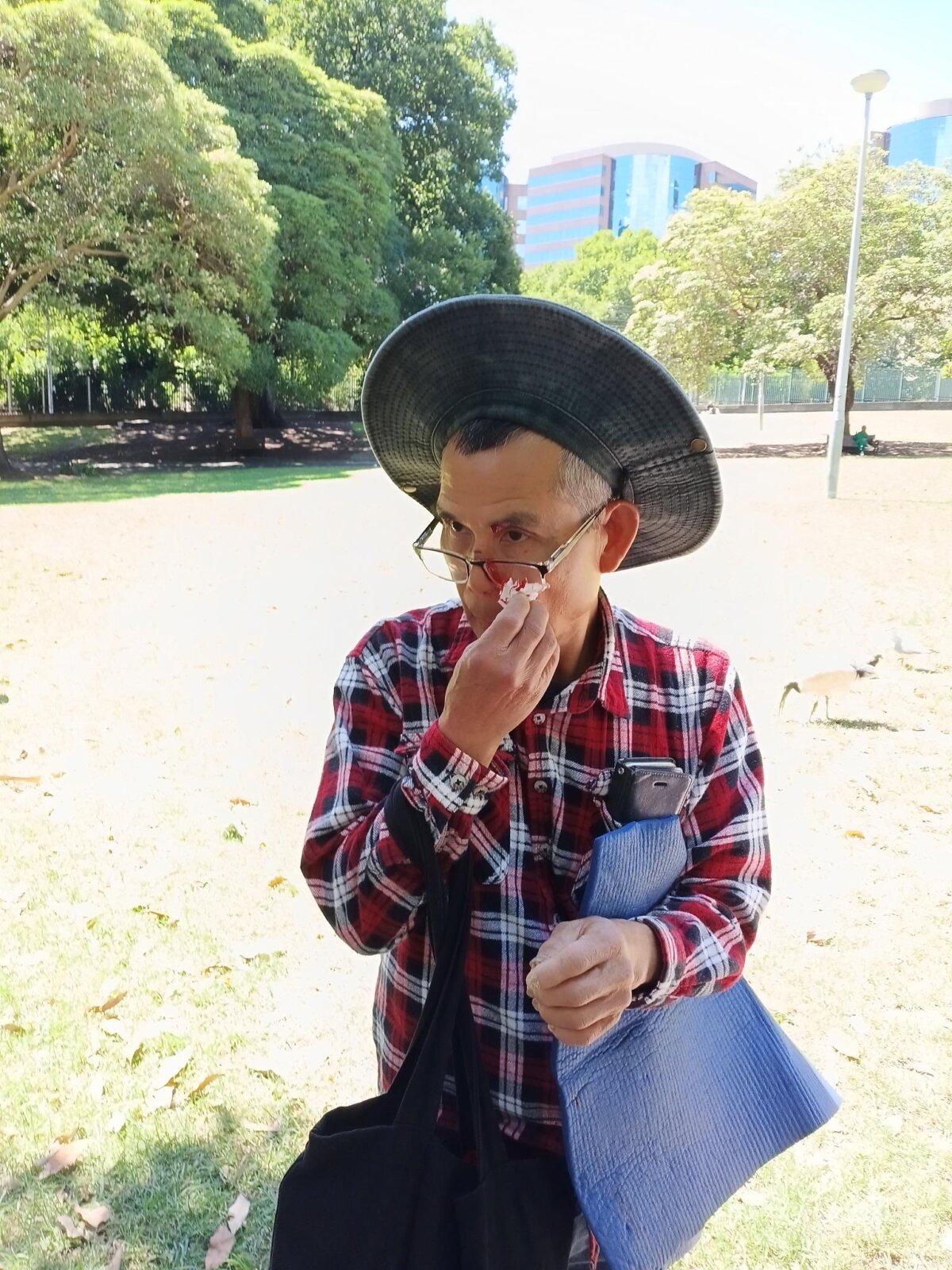 Kun Li, a Falun Gong practitioner who was struck with an empty wine bottle by Kane Hodges in Belmore Park, Sydney, on Dec. 2, 2025. (Courtesy of Falun Gong practitioners)