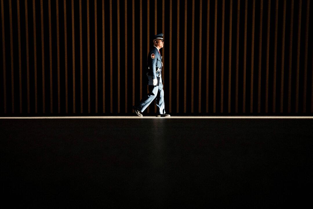 A security worker walks in a ray of light at the Tokyo International Forum on Dec. 4, 2025. (Yuichi Yamazaki/AFP via Getty Images)