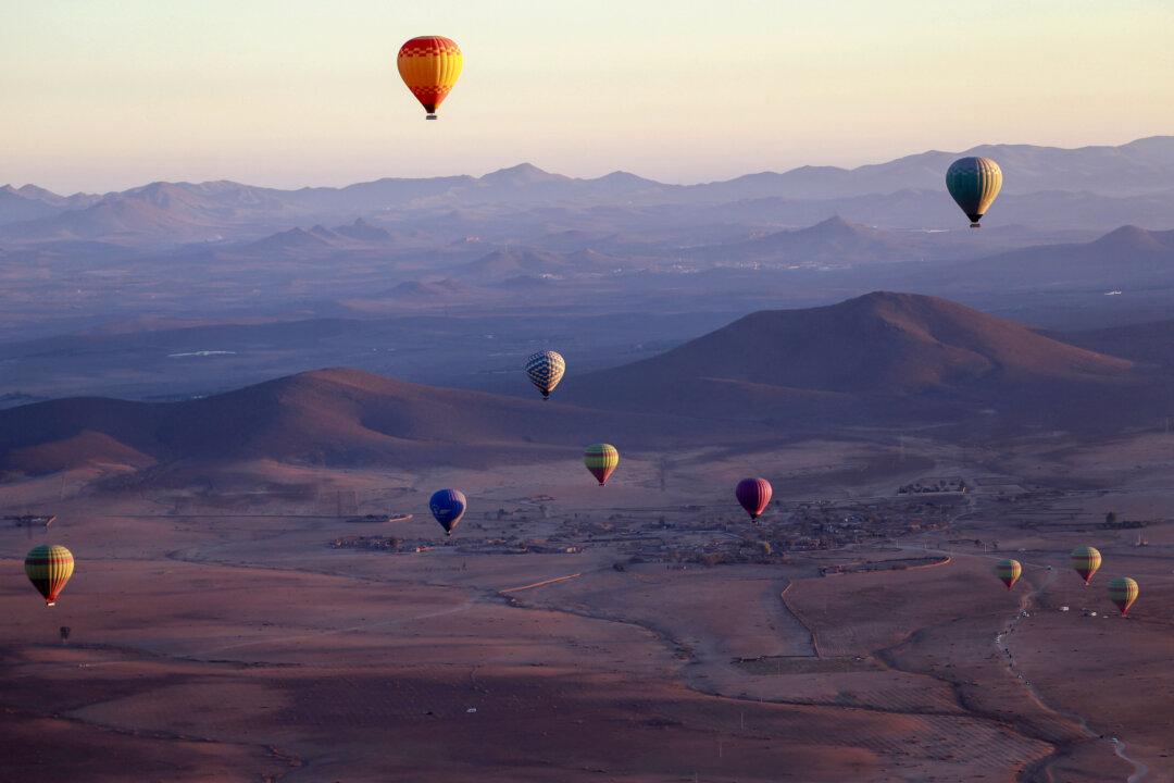 Hot air balloons fly over the Haouz plain north of Marrakesh, Morocco, on Dec. 4, 2025. (Abdel Majid Bziouat/AFP via Getty Images)