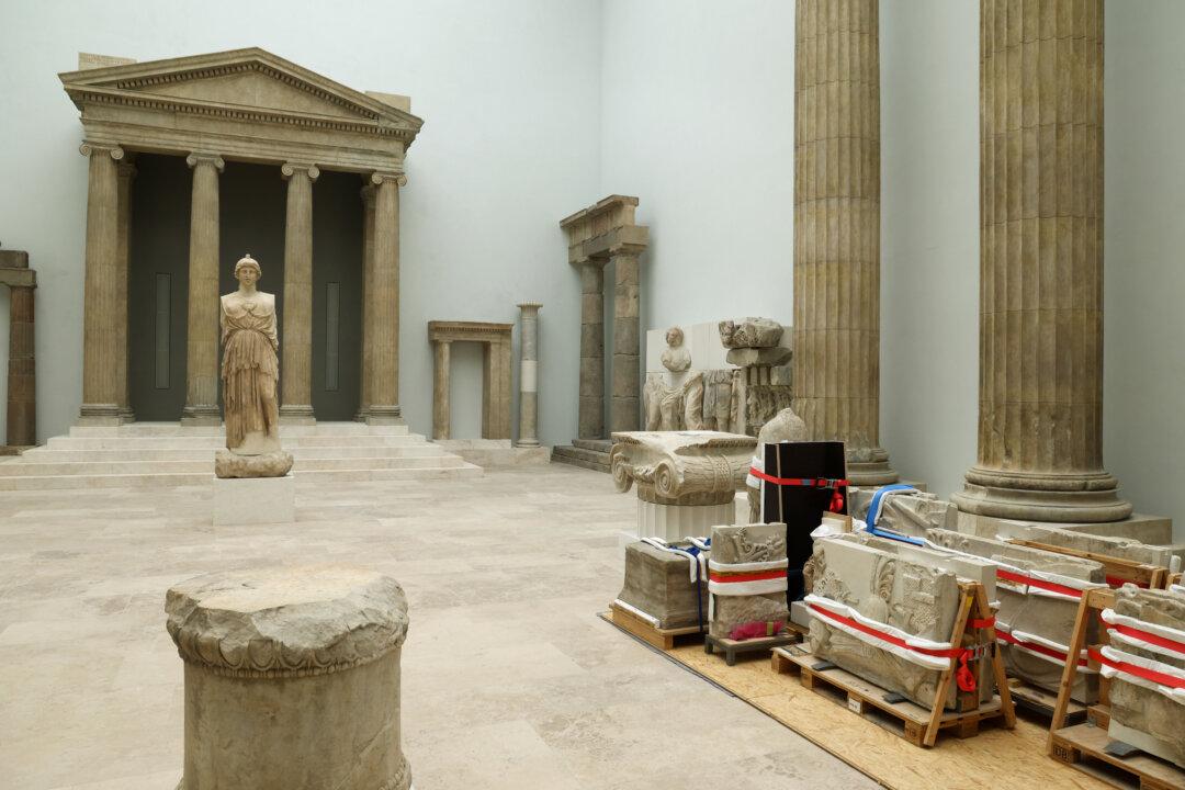 Objects from the Antiquity Collection stand protected near the Athena Parthenos statue at the Pergamon Museum during renovation work in Berlin on Dec. 4, 2025. A part of the Pergamon, including the altar, the Museum of Islamic Art, the Mshatta Facade, and objects of the Antiquity Collection are scheduled to reopen to visitors by spring 2027. (Sean Gallup/Getty Images)