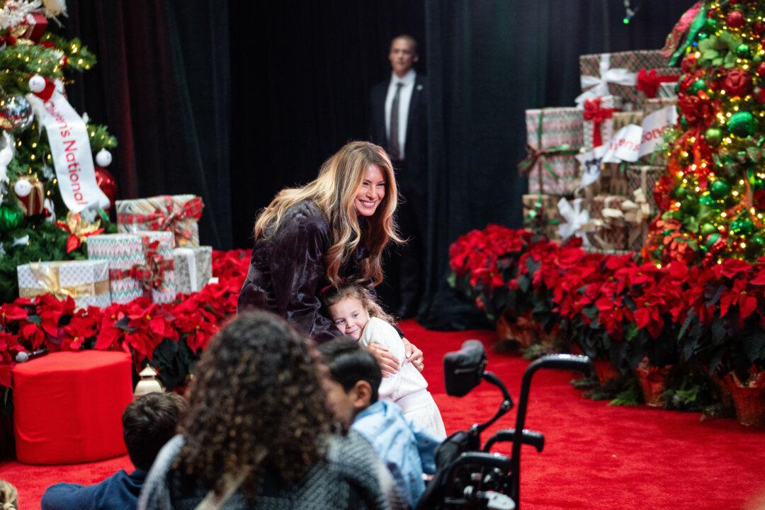 Faith Hinkle hugs First Lady Melania Trump during a visit to the Children’s National Hospital in Washington on Dec. 5, 2025. (Madalina Kilroy/The Epoch Times)