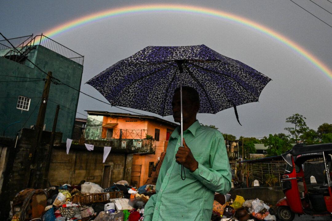 A man walks past a rainbow in Wellampitiya on the outskirts of Colombo, Sri Lanka, on Dec. 5, 2025. (Ishara S. Kodikara/AFP via Getty Images)