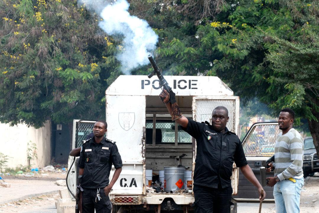 Police repel students from Maurice Delafosse High School who block the street in front of their school by burning tires in Dakar, Senegal, on Dec. 5, 2025. Students are demanding the payment of overdue scholarships. (Seyllou/AFP via Getty Images)