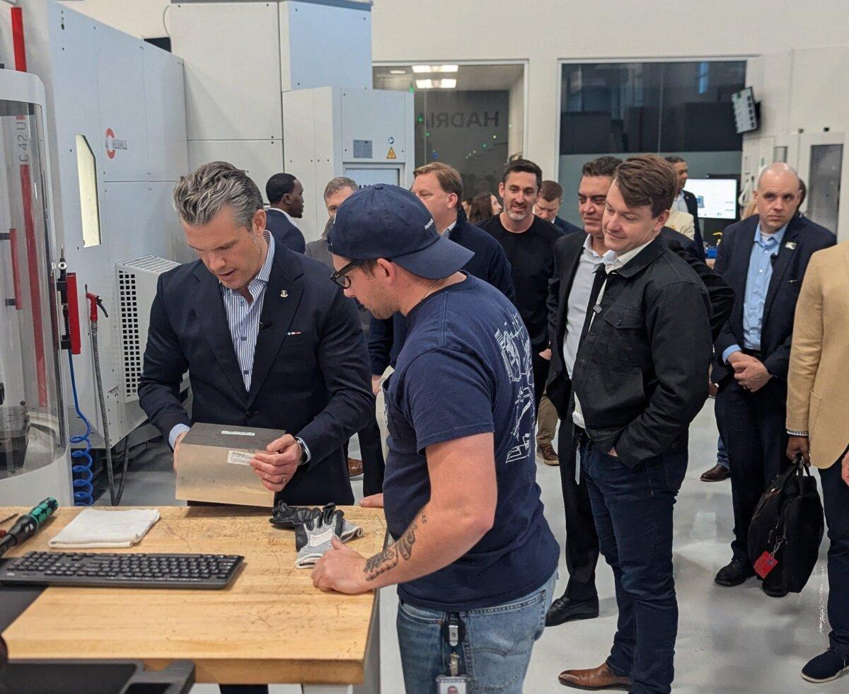 Secretary of War Pete Hegseth prepares to mill a satellite component during a tech demonstration at a Hadrian manufacturing facility in Torrance, Calif., on Dec. 5, 2025. (Ryan Morgan/The Epoch Times)