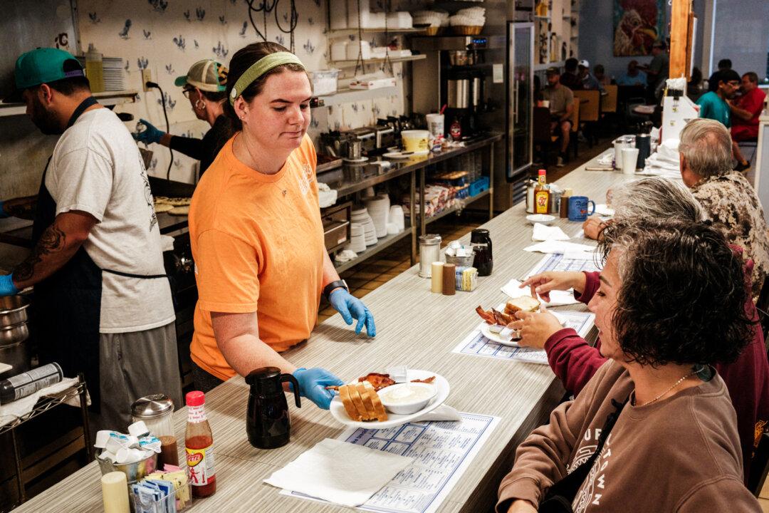 A woman serves breakfast at a restaurant in North Carolina. (Yasuyoshi Chiba/ AFP via Getty Images)