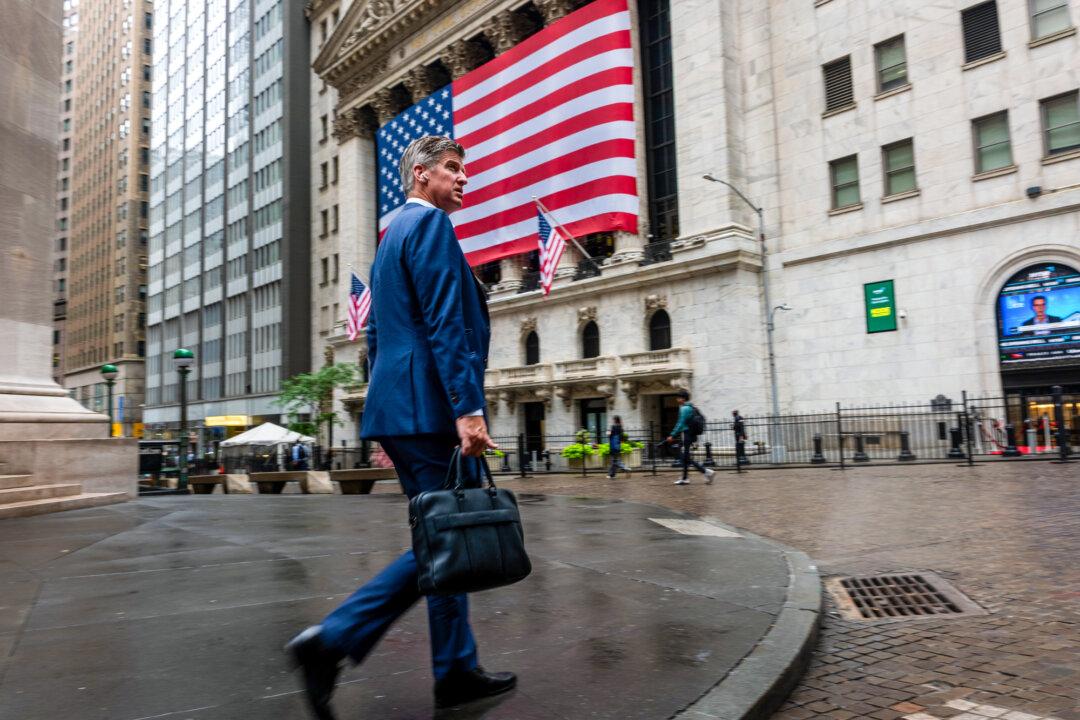 A businessman walks by the New York Stock Exchange in New York City on July 7, 2025. Kiyosaki predicts volatility in the stock market that could negatively impact many current and future retirees who invested their savings in index funds, 401(k) plans, IRA accounts, and other traditional financial instruments. (Spencer Platt/Getty Images)