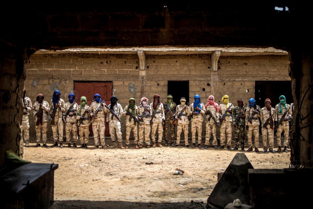 A group of armed Fulani militiamen pose for a picture at an informal demobilization camp in Sevare, Mali, on July 6, 2019. Open Doors, an organization that tracks persecution of Christians, reported that Fulani militants were responsible for 55 percent of recorded Christian deaths from 2019 to 2023. (Marco Longari/AFP via Getty Images)
