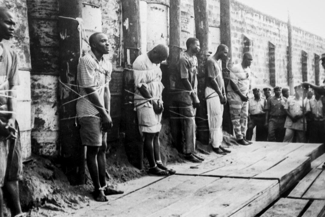 Six men condemned for armed robbery stand before their execution by firing squad at Kirikiri Prison in Lagos, Nigeria, on Feb. 21, 1998. Since Nigeria’s 1999 return to civilian rule, 12 northern states have reintroduced Islamic criminal law, known as sharia, which human rights advocates say has been used to justify mob violence and state-sanctioned capital punishment. (AFP via Getty Images)