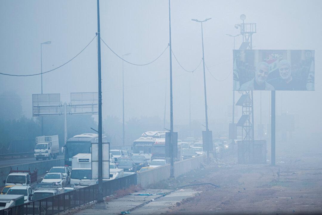 Commuters drive along a highway as thick fog blankets the capital Baghdad, on Dec. 11, 2025. Iraqi authorities temporarily closed Baghdad International Airport early on Dec. 11 due to reduced visibility, the transport ministry said. (Murtadha Ridha/AFP via Getty Images)