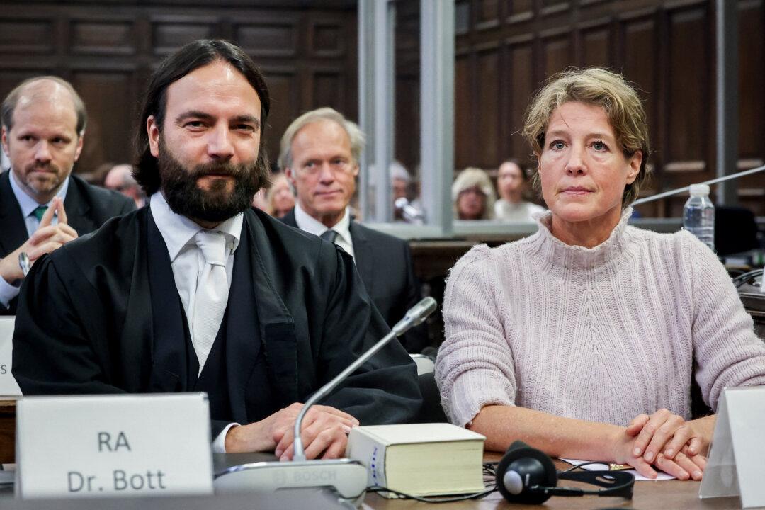 Defendant German entrepreneur and gastronome Christina Block (R) and her lawyer Ingo Bott (2nd L) are pictured ahead of the continuation of the trial against her over alleged child abduction at the District Court in Hamburg, Germany, on Dec. 11, 2025. In the background (C) is Block's partner and co-defendant, Gerhard Delling, former German sports journalist. The public prosecutor's office accuses Block, heiress of a steakhouse chain, of ordering the abduction of her daughter, born in 2010, and her son, born in 2013. (Christian Charisius/POOL/AFP via Getty Images)