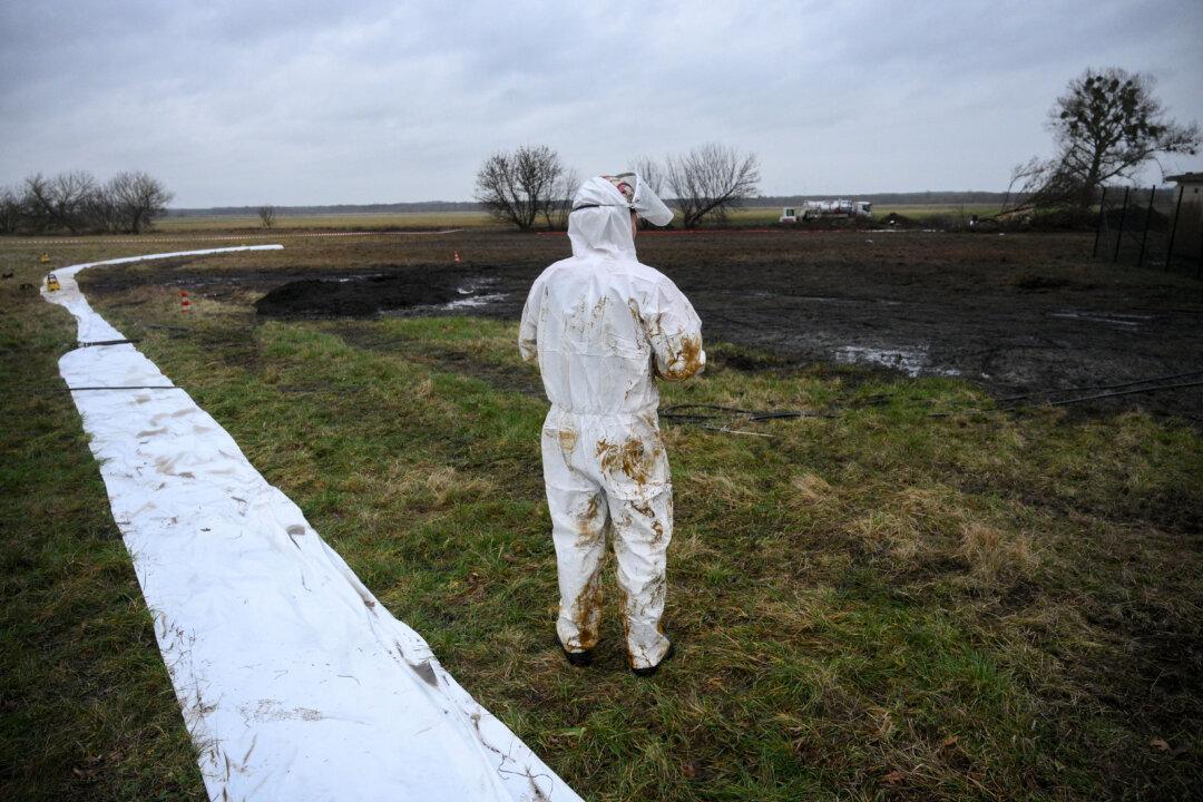 Workers clean up following a leak in an oil pipeline of the PCK refinery in Gramzow, Germany, on Dec. 11, 2025. The PCK refinery near the border with Poland is majority-owned by Rosneft Deutschland, a local subsidiary of the Russian oil giant, and managed through a trusteeship by the German government (Ralf Hirschberger/AFP via Getty Images)