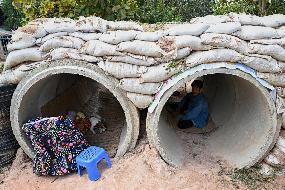 A displaced resident takes shelter in a bunker in the Thai border province of Surin, Thailand, on Dec. 11, 2025, amid clashes along the Thai–Cambodia border. Renewed fighting raged on Dec. 11, with combat heard near centuries-old temples, ahead of an expected phone call from U.S. President Donald Trump to the two nations' leaders. (Lillian Suwanrumpha/AFP via Getty Images)