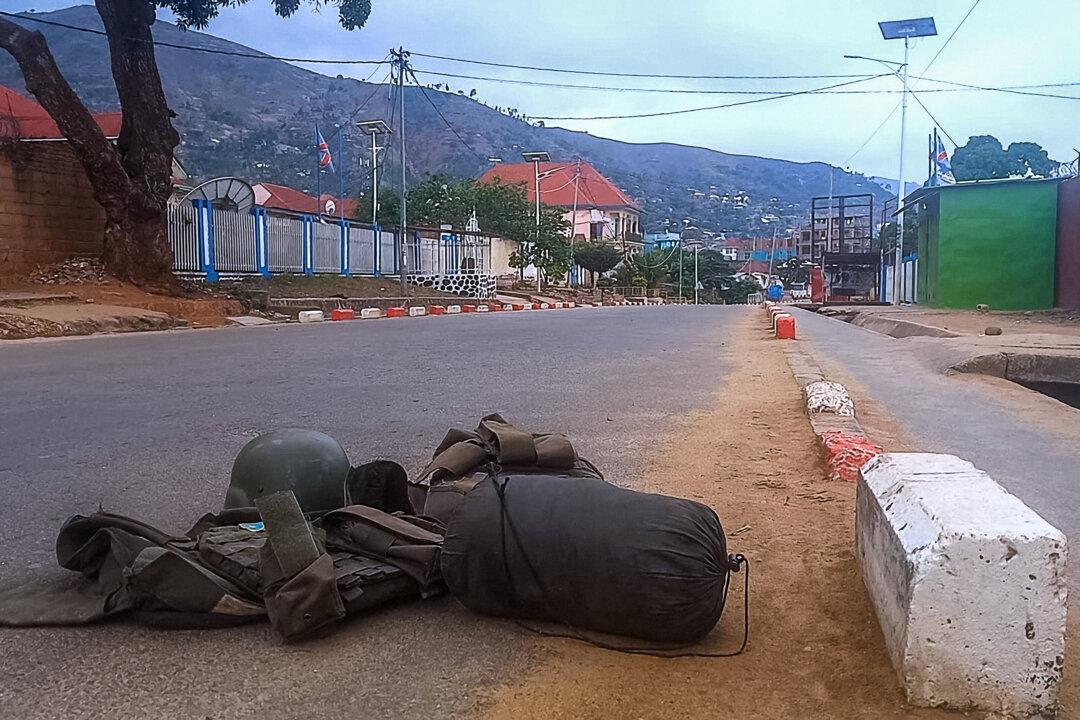 A bulletproof vest carrying a patch with the Democratic Republic of Congo (DRC) flag and a ballistic helmet are left abandoned with other personal belongings in a street in Uvira, Democratic Republic of Congo, on Dec. 11, 2025. Those unable to flee Uvira, a town in the east of the DRC, wait anxiously to learn their fate at the hands of the M23 armed group, backed by the Rwandan army, which on Thursday tightened its grip on the city. (AFP via Getty Images)