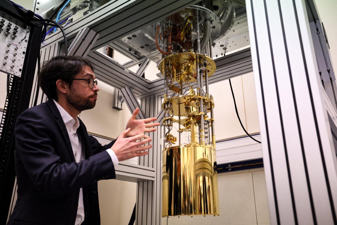 Quantum metrology research engineer Francois Couedo presents measurement instruments, a quantum calculator from the laboratory of characterization of solid-state Qubit and enabling technologies, during the presentation of the MetriQs-France platform which provides reliable measurements for quantum technology, in Trappes, southwest of Paris, on Dec. 11, 2025. (Anne-Christine Poujoulat/AFP via Getty Images)