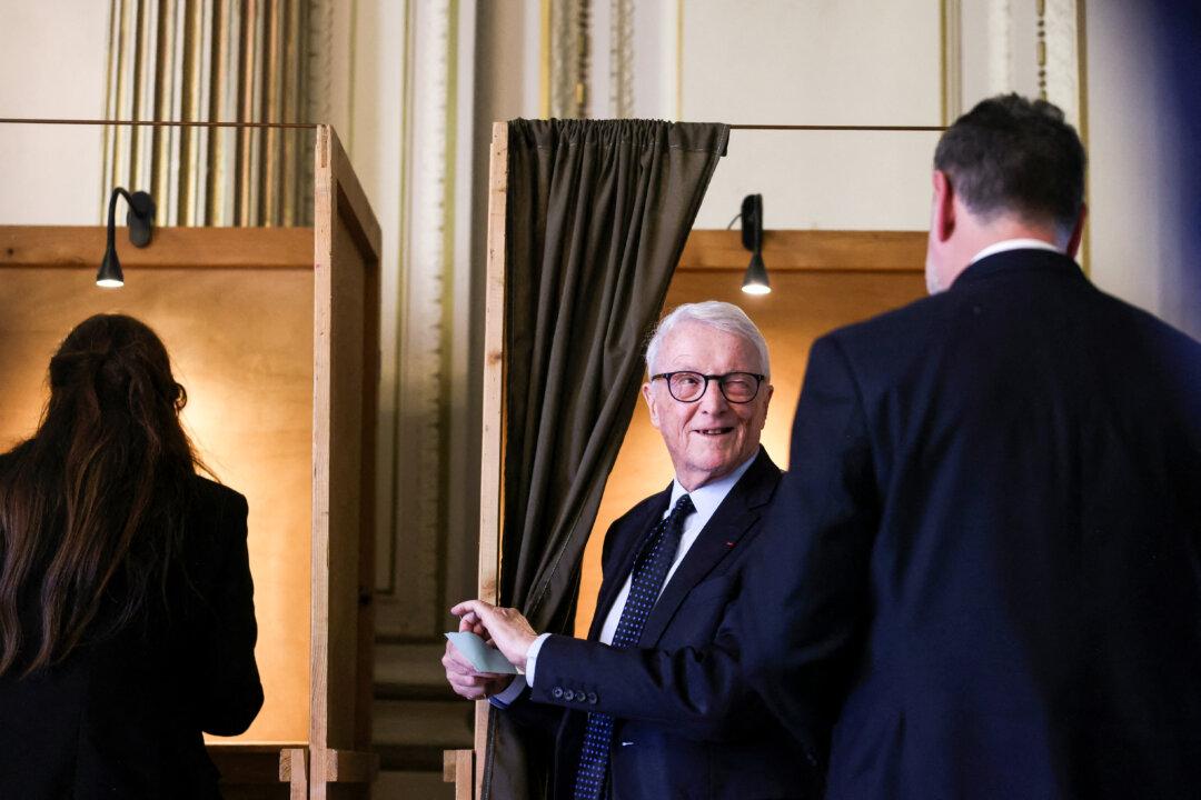 Saint-Etienne Acting Mayor's candidate Jean-Pierre Berger leaves the voting booth after casting his ballot during a city council meeting to elect a new acting mayor, before the local elections of 2026, in Saint-Etienne, France, on Dec. 11, 2025. The previous mayor of Saint-Etienne, Gael Perdriau, resigned after being convicted to five years in prison, four of which are to be served without parole, in the so-called sex-tape blackmail case. (Alex Martin/AFP via Getty Images)
