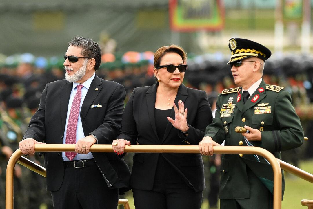 Honduran President Xiomara Castro, Vice Minister of the National Defense Secretariat Orlando Garner (L) and Chief of the Armed Forces General Roosevelt Hernandez (R) review the troops during the celebration of the 200th anniversary of the Honduran Army in Tegucigalpa, on Dec. 11, 2025. (Orlando Sierra/AFP via Getty Images)