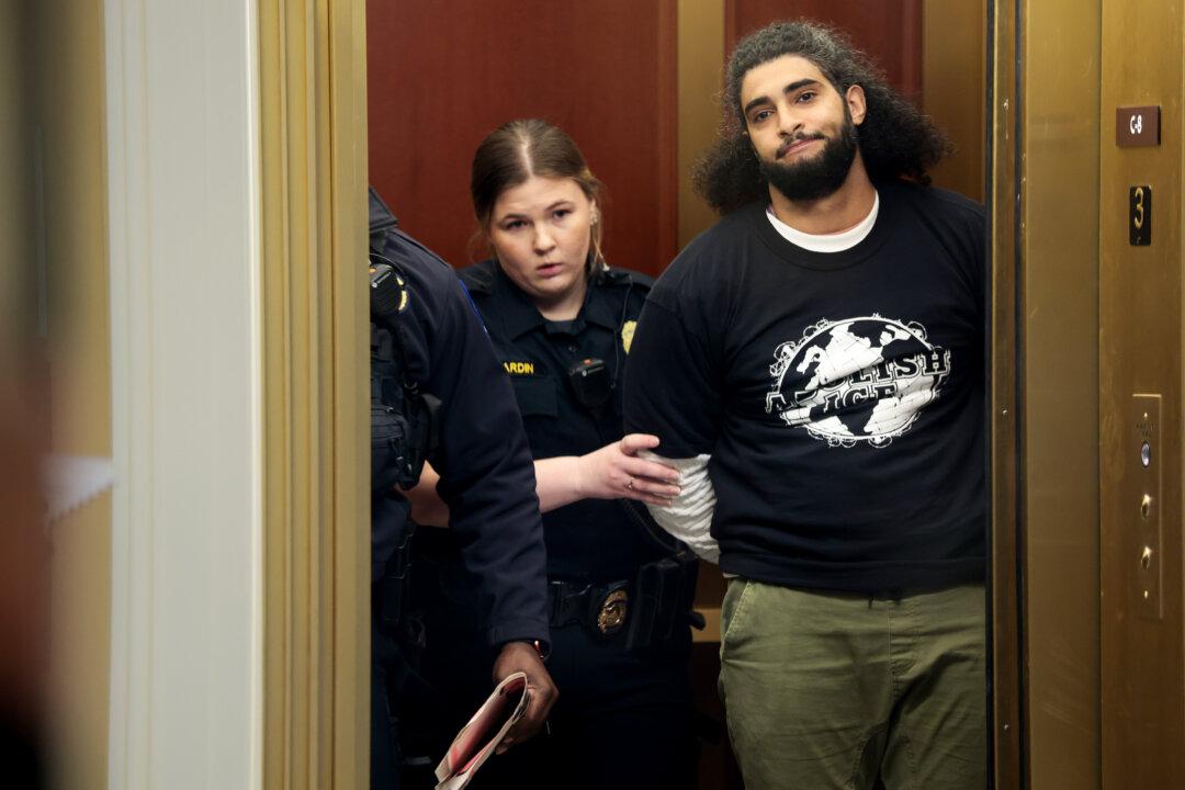 A protester is detained after disrupting a House Committee on Homeland Security hearing in the Cannon House Office Building in Washington on Dec. 11, 2025. The committee convened to hear testimony from top national security officials on potential worldwide threats. (Heather Diehl/Getty Images)