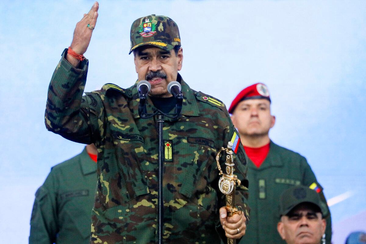 Venezuelan President Nicolas Maduro holds Simon Bolivar's sword as he addresses members of the armed forces, Bolivarian Militia, police, and civilians during a rally against a possible escalation of U.S. actions toward the country, at Fort Tiuna military base in Caracas, Venezuela, on Nov. 25, 2025. (Leonardo Fernandez Viloria/Reuters)