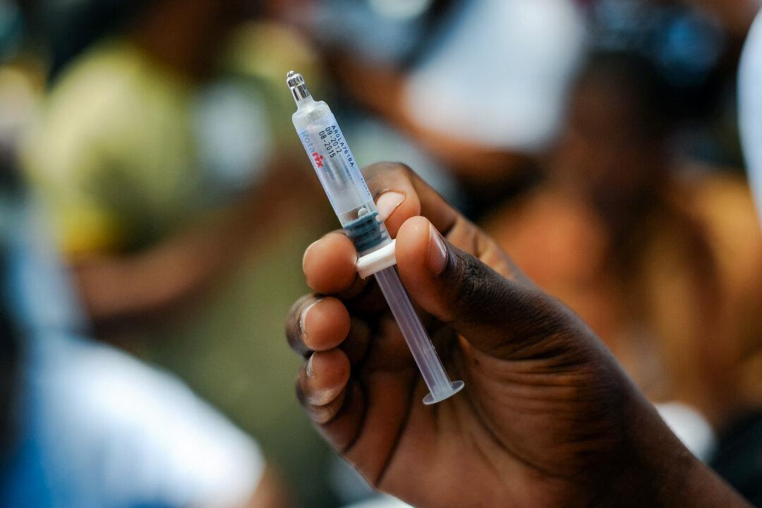 A nurse prepares a rotavirus vaccine for a baby in Port-au-Prince, Haiti, on April 29, 2014. In the United States, infants receive two or three doses under CDC guidelines, a recommendation that could change under Trump’s order. (Hector Retamal/AFP via Getty Images)
