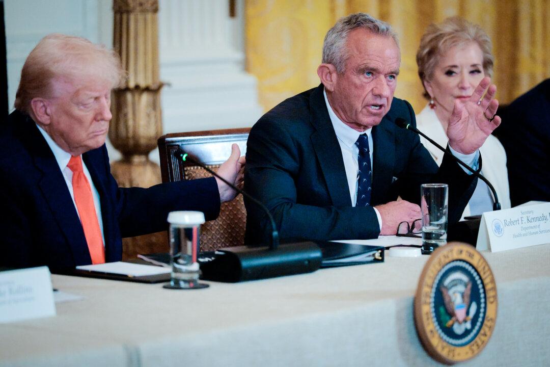 (L–R) President Donald Trump, Health Secretary Robert F. Kennedy Jr., and Education Secretary Linda McMahon present a Make America Healthy Again Commission report at the White House on May 22, 2025. Earlier this month, Trump directed Kennedy and the CDC director to review childhood vaccination recommendations in other developed countries. (Chip Somodevilla/Getty Images)