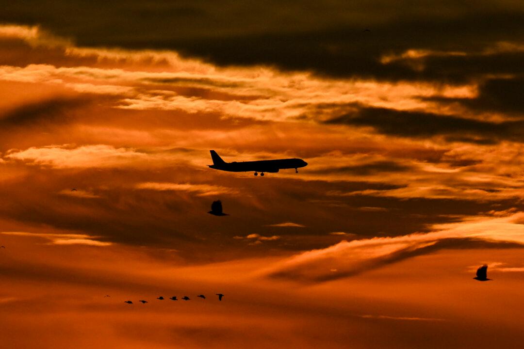 An airplane in the cloudy sky before landing at the Frankfurt airport during sunrise in Frankfurt am Main, Germany, on Dec. 12, 2025. (Kirill Kudryavtsev/AFP via Getty Images)