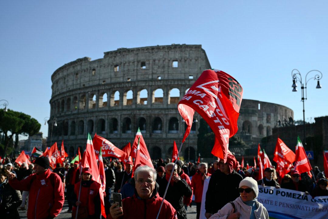 People march near the Colosseum during a national day of strike by Italian union Confederazione Generale Italiana del Lavoro against the government's budget law, on Dec. 12, 2025. (Alberto Pizzoli/AFP via Getty Images)