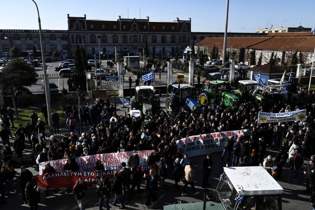 Farmers take part in a demonstration as they block, with tractors, the port of Thessaloniki, Greece, on Dec. 12, 2025. Thousands of Greek farmers have since late November 2025 blocked highways, mainly in the center and north of the country, to demand swifter access to EU subsidies delayed by an ongoing probe into multi-million-dollar fraud. (Sakis Mitrolidis/AFP via Getty Images)