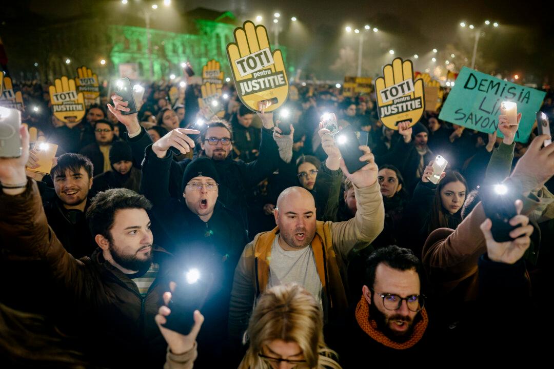 Protesters take part in a rally in Bucharest, Romania, on Dec. 12, 2025. The “Captured Justice” documentary released by independent Romanian investigative journalism outlet Recorder exposes a deep justice crisis marked by political interference, systemic corruption, and the steady erosion of judicial independence. (Andrei Pungovschi/Getty Images)