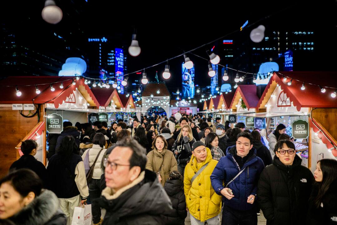People visit a Christmas-themed market during the opening night of the Winter Festa in Seoul, South Korea, on Dec. 12, 2025. (Anthony Wallace/AFP via Getty Images)