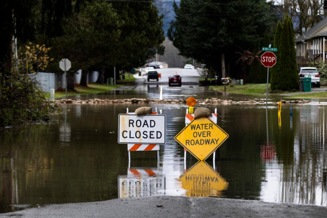 A road is blocked to traffic following severe flooding in Burlington, Washington, on Dec. 12, 2025. Following days of heavy rain, many cities in Washington have seen rivers swell and spill over banks, causing widespread flooding and property damage. (Natalie Behring/Getty Images)