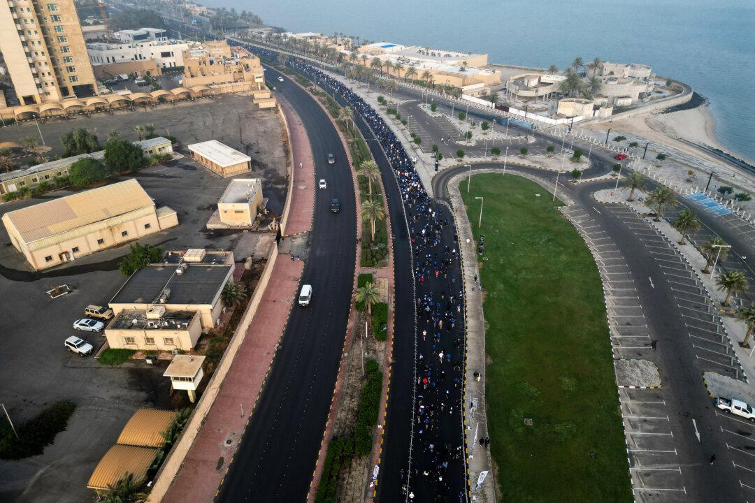 An aerial photograph shows runners participating in a marathon in Kuwait City, on Dec. 13, 2025. (Yasser Al-Zayyat/AFP via Getty Images)