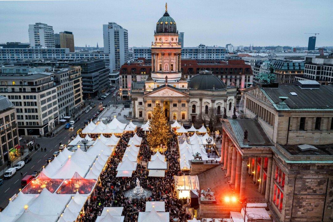 Visitors crowd the Christmas market on the Gendarmenmarkt in Berlin, on Dec. 13, 2025. (John Macdougall/AFP via Getty Images)