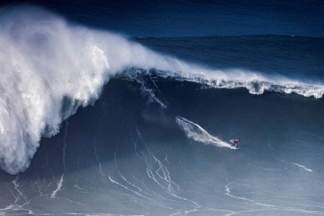 Joao Chianca of Brazil rides a wave during a WSL big wave challenge surfing session in Nazare, Portugal, on Dec. 13, 2025. (Filipe Amorim/AFP via Getty Images)