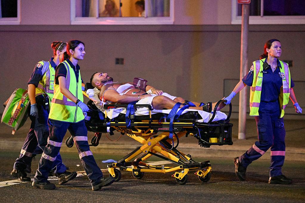 Health workers move a man on a stretcher to an ambulance after a shooting incident at Bondi Beach in Sydney on Dec. 14, 2025. (Saeed Khan/AFP via Getty Images)