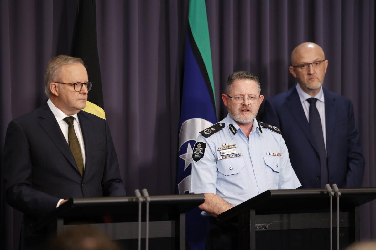 (L–R) Australian Prime Minister Anthony Albanese, Australian Labor Party Acting Deputy Commissioner for National Security Nigel Ryan, and Australian Director-General of Security Mike Burgess speak to reporters in Canberra, Australia, on Dec. 14, 2025. (Hilary Wardhaugh/Getty Images)