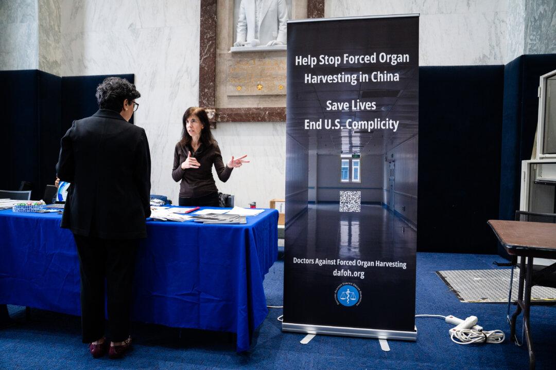 Representatives of the Doctors Against Forced Organ Harvesting organization take part in the China Human Rights Fair at the Rayburn House Office Building on Capitol Hill in Washington on Dec. 10, 2025. (Madalina Kilroy/The Epoch Times)