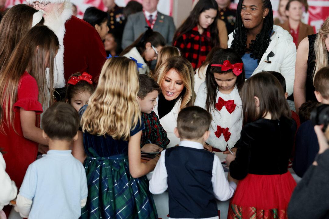 First lady Melania Trump visits with children of service members during a Toys for Tots Charity Drive at Marine Corps Base Quantico in Quantico, Va., on Dec. 8, 2025. Trump delivered remarks to military families and helped children make Christmas cards and sort toys. (Anna Moneymaker/Getty Images)