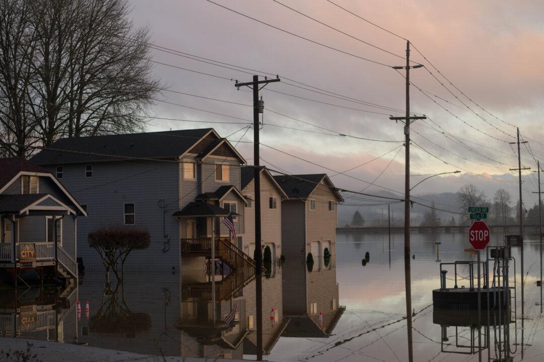 Water from the Snohomish River partially submerges some homes in Snohomish, Wash., on Dec. 12, 2025. Following days of heavy rain, many cities in Washington have seen rivers swell and spill over banks, causing widespread flooding and property damage. (Natalie Behring/Getty Images)