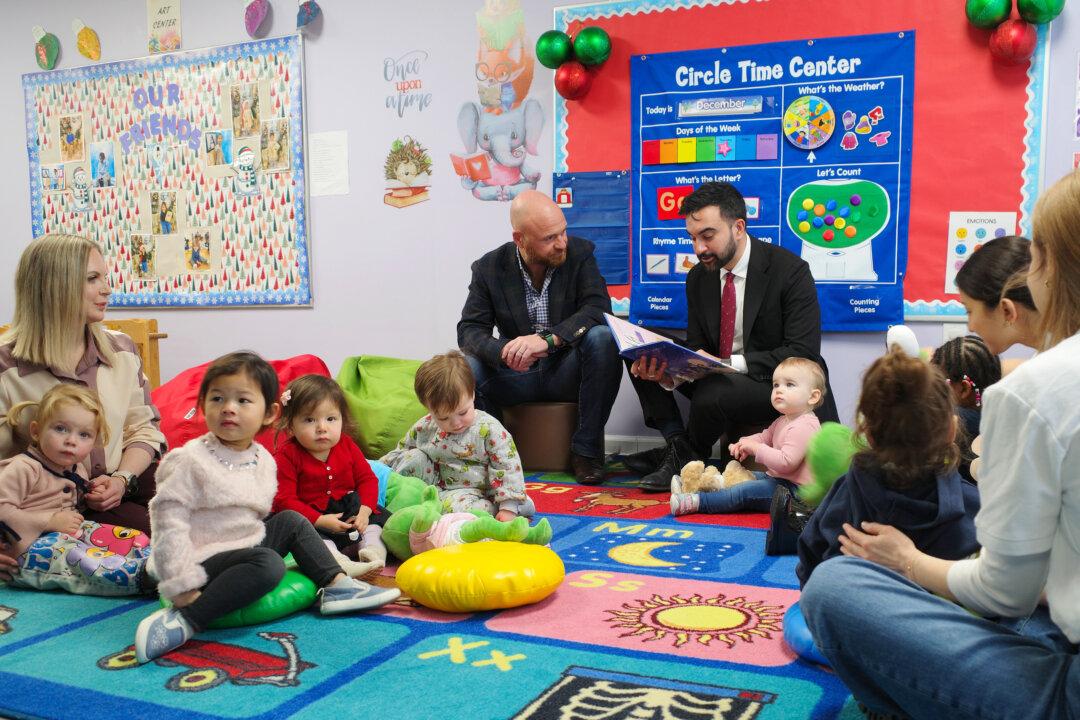 New York City Mayor-elect Zohran Mamdani reads a Christmas book to students at Little Scholars in New York City on Dec. 11, 2025. Mamdani visited a school and met with educators to speak about the importance of his campaign promise of universal child care after meeting with business leaders to discuss how to fund the plan. (Michael M. Santiago/Getty Images)