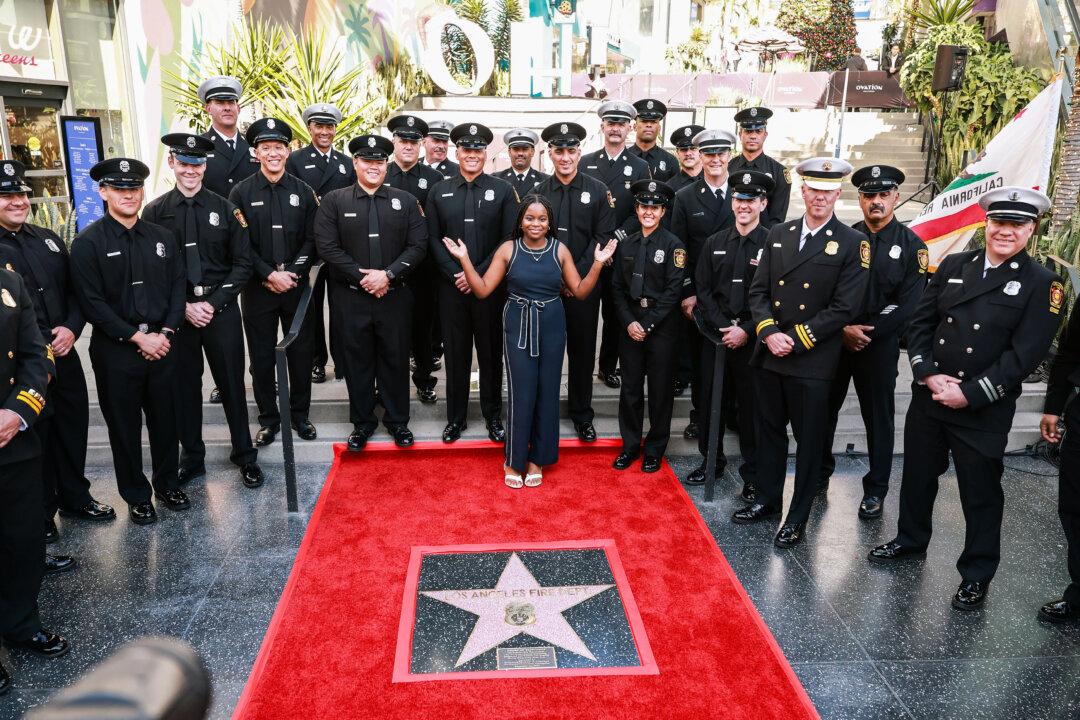 LAFD Chief Jaime E. Moore, Eniola Taiwo, and LAFD firefighters pose with their star on the Hollywood Walk of Fame during the Hollywood Chamber of Commerce Honors the Los Angeles Fire Department with Award of Excellence event in Los Angeles on Dec. 12, 2025. (Matt Winkelmeyer/Getty Images)