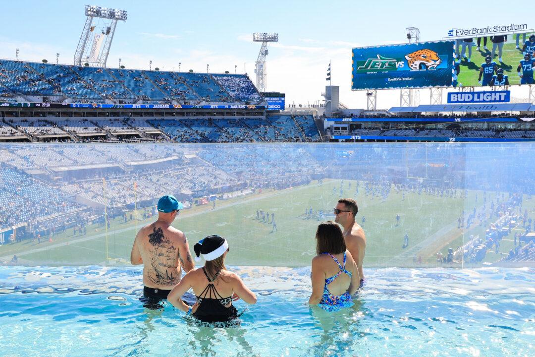 Fans watch players warm up from a pool before the game between the Jacksonville Jaguars and the New York Jets at EverBank Stadium in Jacksonville, Fla., on Dec. 14, 2025. (Mike Carlson/Getty Images)