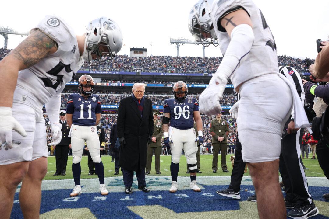 President Donald Trump participates in the coin toss before the start of the 126th Army-Navy Game between the Army Black Knights and the Navy Midshipmen at M&T Bank Stadium in Baltimore, Md., on Dec. 13, 2025. The teams are competing for the Commander-in-Chief’s Trophy, with Trump attending the rivalry for the second consecutive year. (Tasos Katopodis/Getty Images)