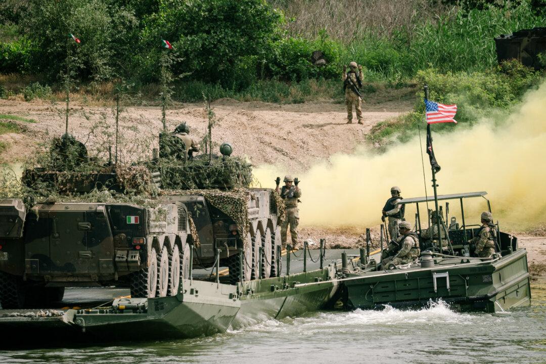 U.S., Romanian, and Italian soldiers take part in a military exercise in Frecatei, Romania, on June 13, 2025. Flynn has suggested increasing U.S. Army engagement with forces from other countries in the Indo-Pacific. (Andrei Pungovschi/Getty Images)