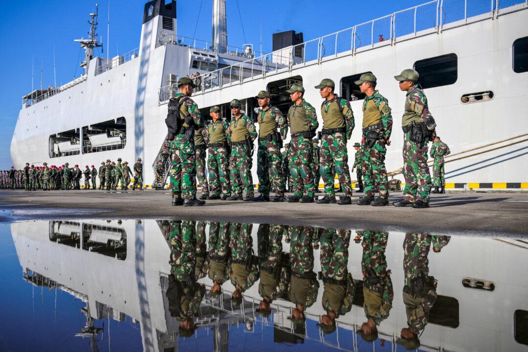 Indonesian National Armed Forces soldiers line up for a departure ceremony in front of the warship KRI Makassar-590 at Tanjung Priok seaport in Jakarta, Indonesia, on Aug. 29, 2025. Ret. Gen. Charles Flynn said Washington often miscasts the Indo-Pacific as a naval or air domain, noting that most Asian militaries are predominantly army, including Indonesia’s, at about 75 percent. (Bay Ismoyo/AFP via Getty Images)